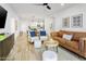 Bright, open living room with hardwood floors, a modern ceiling fan, and stylish furnishings at 2511 W Queen Creek Rd # 165, Chandler, AZ 85248