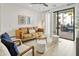 Bright living room with a modern sofa, stylish decor, and sliding glass doors to an outdoor patio at 2511 W Queen Creek Rd # 165, Chandler, AZ 85248