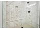 Walk-in shower featuring elegant marble-look tile, a built-in seat and niche, plus a rainfall shower head at 2511 W Queen Creek Rd # 165, Chandler, AZ 85248
