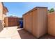 Backyard features a convenient storage shed and privacy fencing for secure outdoor living at 2528 N Ashbrook Cir, Mesa, AZ 85213