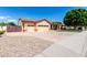 Charming single-story home featuring a three car garage and desert landscaping at 2528 N Ashbrook Cir, Mesa, AZ 85213