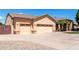 Charming single-story home featuring a three car garage and desert landscaping at 2528 N Ashbrook Cir, Mesa, AZ 85213