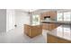 Kitchen featuring light wood cabinets, island with sink, and access to backyard through sliding door at 2528 N Ashbrook Cir, Mesa, AZ 85213
