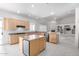 Kitchen and living room combo featuring a kitchen island, light wood cabinets, and neutral decor at 2528 N Ashbrook Cir, Mesa, AZ 85213
