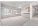 Spacious living room featuring neutral carpeting and bright white walls at 2528 N Ashbrook Cir, Mesa, AZ 85213