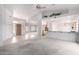 Open-concept living room with access to kitchen, light-colored wood front door, and neutral decor at 2528 N Ashbrook Cir, Mesa, AZ 85213