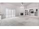 Living room showcasing a fireplace, built-in shelving, carpet, and plantation shutters at 2528 N Ashbrook Cir, Mesa, AZ 85213