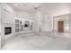 Spacious living room featuring a fireplace, built-in shelving, and a light-colored front door at 2528 N Ashbrook Cir, Mesa, AZ 85213