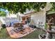 Charming backyard with a cozy sitting area, a fire pit, decorative water feature, and lush greenery at 33 W Missouri Ave # 17, Phoenix, AZ 85013
