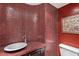 Powder room with red tiled wall and vessel sink at 33 W Missouri Ave # 17, Phoenix, AZ 85013