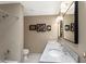 Bathroom featuring a double vanity with granite countertop and decorative artwork at 33 W Missouri Ave # 17, Phoenix, AZ 85013