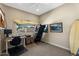 Bedroom with ceiling fan, surfboards, exercise equipment and a desk area at 33 W Missouri Ave # 17, Phoenix, AZ 85013