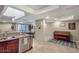 Bright kitchen with modern appliances, skylight, and open layout that flows into the dining area with a piano at 33 W Missouri Ave # 17, Phoenix, AZ 85013