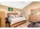 Cozy bedroom featuring a wooden bed frame and matching dresser, exuding warmth and comfort at 3308 N Nebraska St, Chandler, AZ 85225