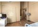 Bedroom with neutral paint and flooring, large closet, white desk and view to the hall at 3308 N Nebraska St, Chandler, AZ 85225