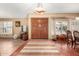 Spacious foyer with wood-look floors, double front doors, and an elegant pendant light fixture at 3308 N Nebraska St, Chandler, AZ 85225