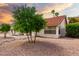 Home exterior featuring desert landscaping with rock and palm trees, offering easy maintenance at 3308 N Nebraska St, Chandler, AZ 85225