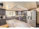Kitchen featuring an island, stainless steel appliances, and sleek gray cabinets at 3308 N Nebraska St, Chandler, AZ 85225