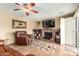 Cozy living room featuring a fireplace, ceiling fan and comfortable leather armchair at 3308 N Nebraska St, Chandler, AZ 85225