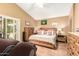 Main bedroom featuring a king bed, neutral decor, and access to outdoor living space at 3308 N Nebraska St, Chandler, AZ 85225