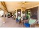 Covered patio with ceiling fan and chairs, offering a relaxing outdoor space at 3308 N Nebraska St, Chandler, AZ 85225