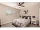 Bedroom featuring a ceiling fan, large window, and plush bedding at 3502 W Gardenia Ave, Phoenix, AZ 85051