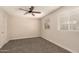 Large bedroom with carpet, ceiling fan and two windows at 3502 W Gardenia Ave, Phoenix, AZ 85051