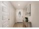 Welcoming entryway with a decorative door and modern console table with plant accent at 3502 W Gardenia Ave, Phoenix, AZ 85051