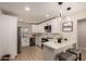 Bright kitchen with white cabinets, stainless steel appliances, and modern countertops at 3502 W Gardenia Ave, Phoenix, AZ 85051