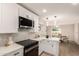 The upgraded kitchen has modern appliances, white cabinets, and quartz countertops at 3502 W Gardenia Ave, Phoenix, AZ 85051