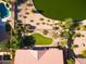 Aerial view showcasing a property with a pool, pond, well-manicured lawn, and lush landscaping at 3750 E Sawtooth Dr, Chandler, AZ 85249
