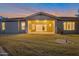 Backyard view showing a covered patio, lush green lawn, and beautiful sunset skies at 3750 E Sawtooth Dr, Chandler, AZ 85249