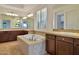 Elegant bathroom featuring a drop-in tub, dual mirrors, and plenty of counter space at 3750 E Sawtooth Dr, Chandler, AZ 85249