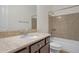 Cozy bathroom with granite countertop vanity, a mirror and tile accenting the bathtub/shower at 3750 E Sawtooth Dr, Chandler, AZ 85249
