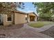 Exterior showcasing desert landscaping, a brick paver walkway, and a covered porch entry at 3750 E Sawtooth Dr, Chandler, AZ 85249