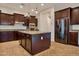 Kitchen with stainless steel appliances and island with granite counter tops and pendant lights at 3750 E Sawtooth Dr, Chandler, AZ 85249