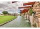 Water feature with multiple small waterfalls, decorative stones, manicured grass, and steel support beams at 3750 E Sawtooth Dr, Chandler, AZ 85249