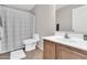 Bathroom features a vanity with wooden cabinets and a shower-tub combo at 3841 E Jasper Dr, Gilbert, AZ 85296