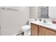 Functional bathroom featuring a wood vanity, white countertop, modern sink, and coordinated fixtures for a clean aesthetic at 3841 E Jasper Dr, Gilbert, AZ 85296