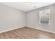 Cozy bedroom with window, luxury vinyl flooring, and neutral paint at 3841 E Jasper Dr, Gilbert, AZ 85296