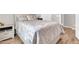 Cozy bedroom with a large decorative bed, wood-look flooring, and a neutral color scheme for a tranquil atmosphere at 3841 E Jasper Dr, Gilbert, AZ 85296