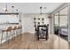 Open dining area featuring modern pendant lighting, slider doors and stylish bar stools at 3841 E Jasper Dr, Gilbert, AZ 85296