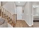 Inviting entryway featuring wood-look floors, a white front door, and a carpeted staircase leading to the upper level at 3841 E Jasper Dr, Gilbert, AZ 85296