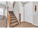Spacious entryway showcasing a carpeted staircase, wood-look flooring, and a white front door with sidelight at 3841 E Jasper Dr, Gilbert, AZ 85296