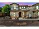 Charming two-story home with stone accents and arched entryway, perfect for a Gathering at 3841 E Jasper Dr, Gilbert, AZ 85296