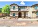 Charming two-story home with stone accents and arched entryway, perfect for a Gathering at 3841 E Jasper Dr, Gilbert, AZ 85296