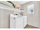 Laundry room featuring white appliances and ample shelf storage at 3841 E Jasper Dr, Gilbert, AZ 85296