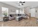 Spacious living room with hardwood floors, ceiling fan, and comfortable seating area at 3841 E Jasper Dr, Gilbert, AZ 85296