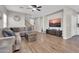 Inviting living room with hardwood floors, ceiling fan, and large sectional sofa at 3841 E Jasper Dr, Gilbert, AZ 85296