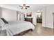 Well-lit main bedroom featuring wood-look floors, a ceiling fan, and a spacious layout leading to a stylish en-suite bathroom at 3841 E Jasper Dr, Gilbert, AZ 85296